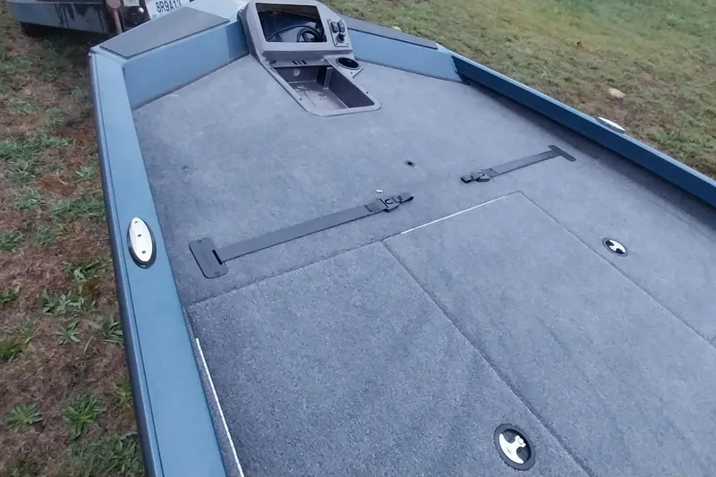 Slide: The Image of 2024 Ranger RT198P boat deck with carpeted surface and storage compartments. - 47