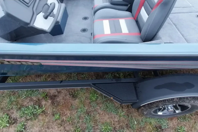 Slide: The Image of 2024 Ranger RT198P boat interior with gray and red seats, trailer visible. - 50