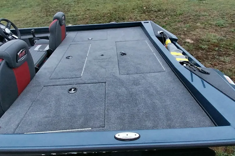 Slide: The Image of 2024 Ranger RT198P boat interior with carpeted deck and storage compartments. - 7