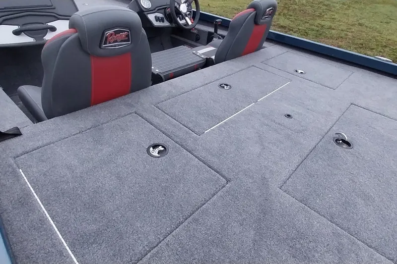 Slide: The Image of 2024 Ranger RT198P boat interior with gray carpet and dual seats. - 8