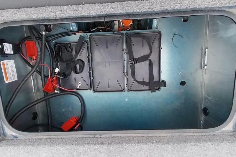 Slide: The Image of 2024 Ranger RT198P boat battery compartment with wiring and secured battery box. - 9