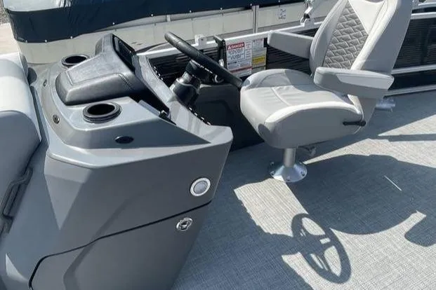 Slide: The Image of 2025 Bennington SLJSR boat interior with steering console and captain's chair. - 3