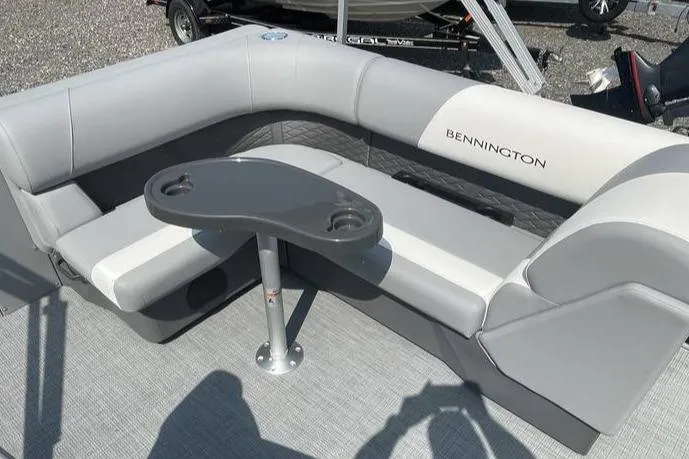 Slide: The Image of 2025 Bennington SLJSR boat interior with gray seating and a small table. - 5