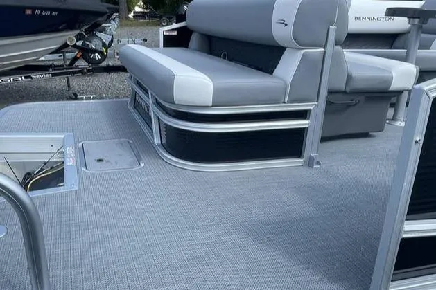 Slide: The Image of 2025 Bennington SLJSR boat interior with gray seating and flooring. - 7