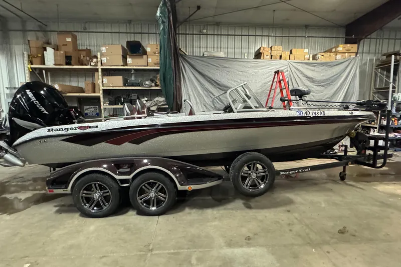 Slide: The Image of 2018 Ranger 621FS Fisherman boat in a garage, on a trailer, with Mercury engine. - 0
