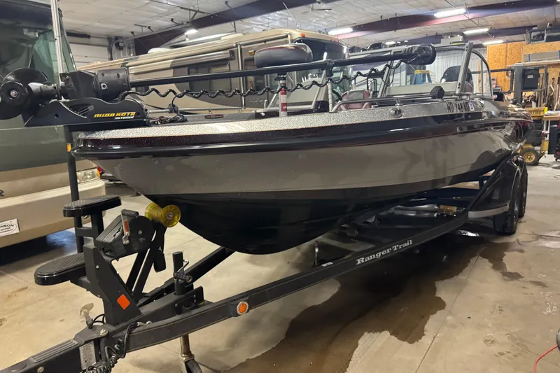 Slide: The Image of 2018 Ranger 621FS Fisherman boat on trailer in a garage setting. - 1