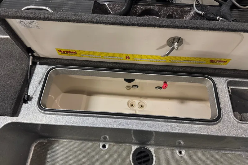 Slide: The Image of 2018 Ranger 621FS Fisherman boat storage compartment with measuring ruler. - 12