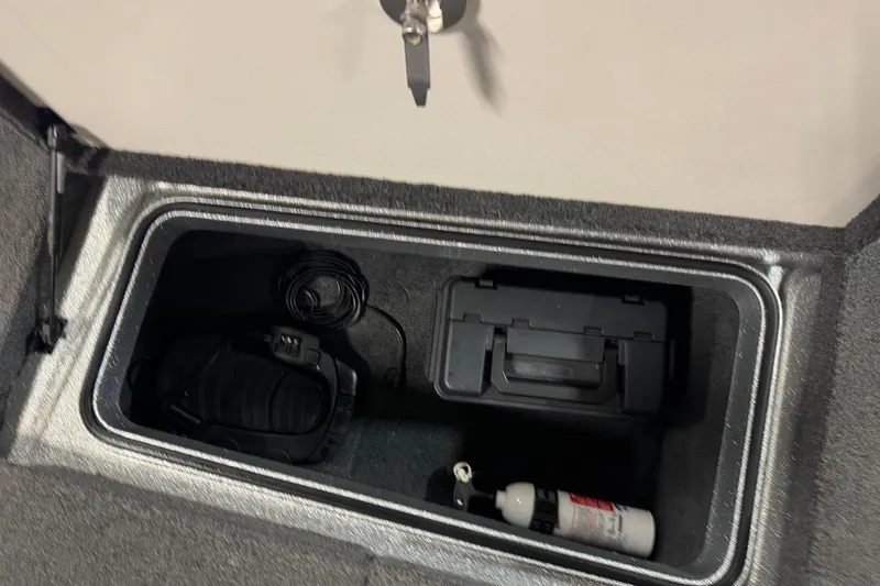 Slide: The Image of Storage compartment in 2018 Ranger 621FS Fisherman boat with equipment and fire extinguisher. - 22