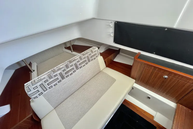 Slide: The Image of Interior of 2023 Pursuit S 328 Sport boat with seating and wood cabinetry. - 17