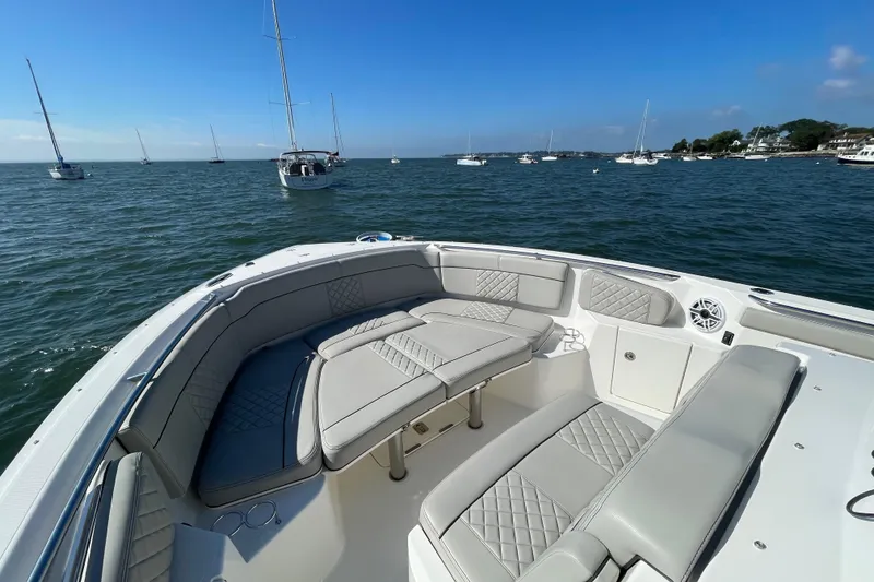 Slide: The Image of 2023 Pursuit S 328 Sport boat with luxurious seating on calm waters. - 19