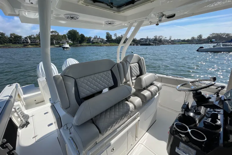 Slide: The Image of 2023 Pursuit S 328 Sport boat interior with luxurious seating and scenic water view. - 24