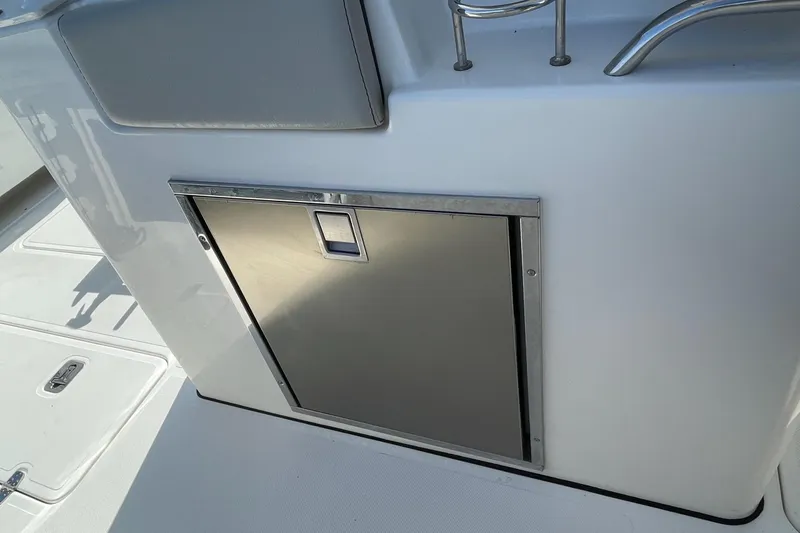 Slide: The Image of 2023 Pursuit S 328 Sport boat interior with stainless steel storage compartment. - 25
