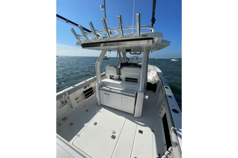 Slide: The Image of 2023 Pursuit S 328 Sport boat interior with ocean view, featuring sleek design and spacious deck. - 29