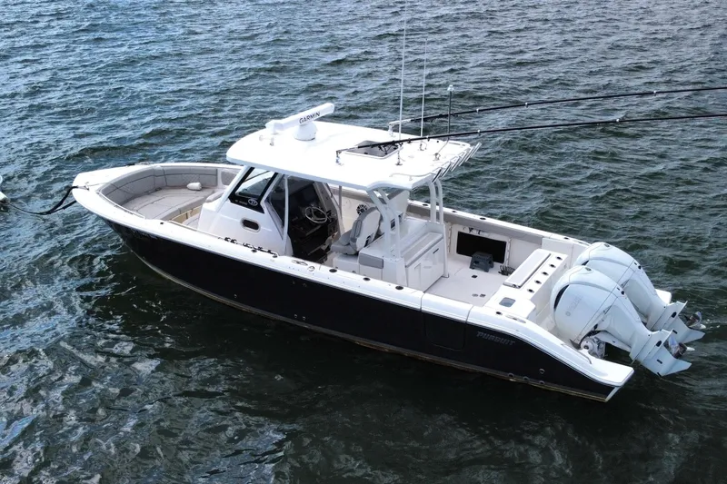 Slide: The Image of 2023 Pursuit S 328 Sport boat on water, featuring dual engines and sleek design. - 3