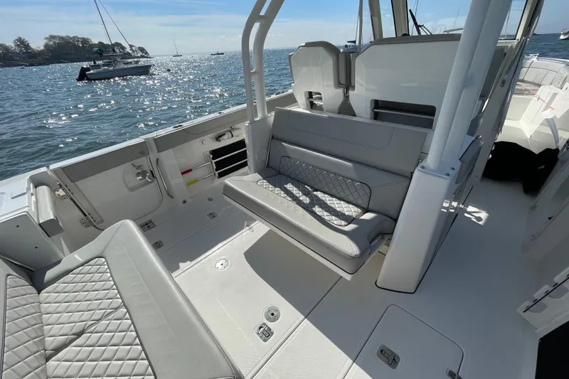 Slide: The Image of 2023 Pursuit S 328 Sport boat interior with luxurious seating and ocean view. - 32
