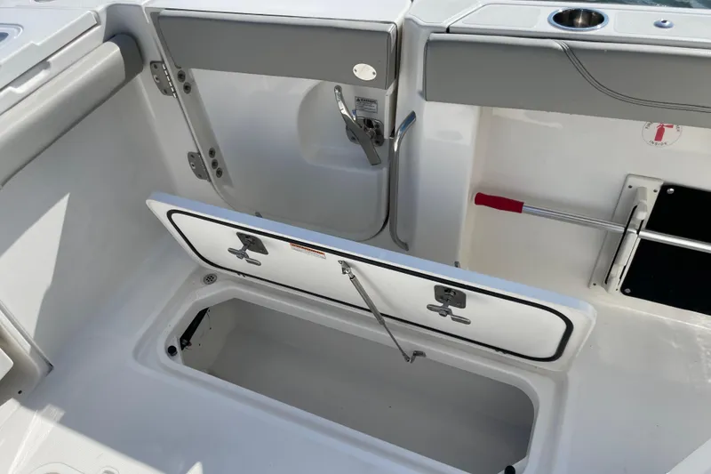 Slide: The Image of 2023 Pursuit S 328 Sport boat interior storage compartment with open hatch. - 34