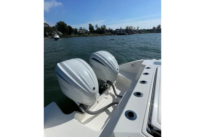 Slide: The Image of 2023 Pursuit S 328 Sport boat with dual outboard engines on a sunny day. - 39