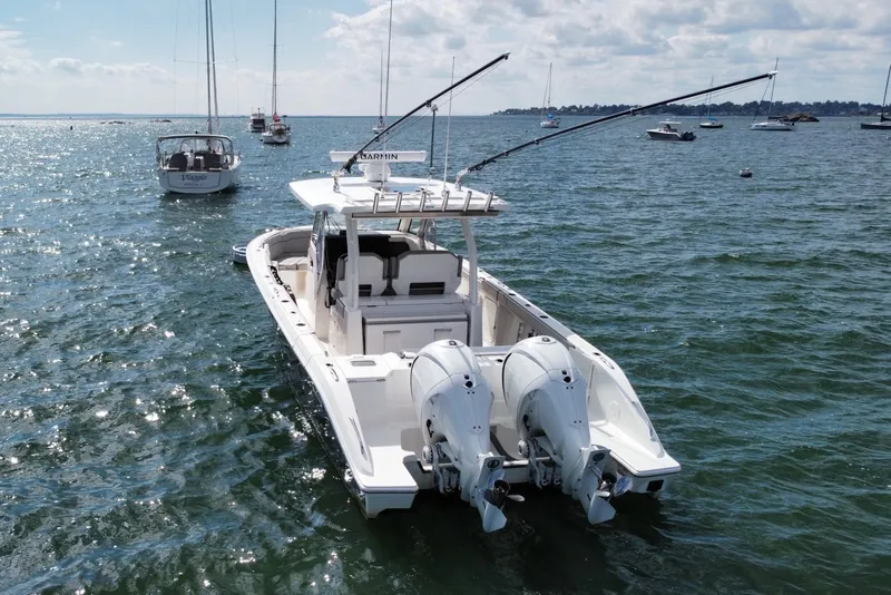 Slide: The Image of 2023 Pursuit S 328 Sport boat on open water with twin engines. - 4