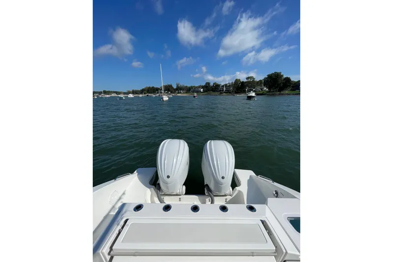 Slide: The Image of 2023 Pursuit S 328 Sport boat with dual engines on a sunny day. - 40