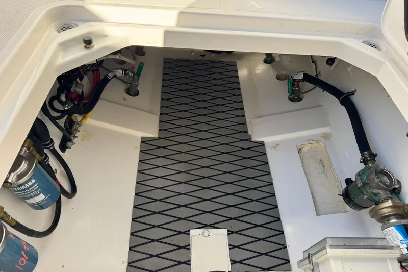 Slide: The Image of 2023 Pursuit S 328 Sport boat interior showing engine compartment and components. - 9
