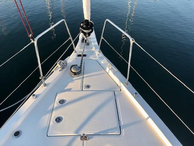 Slide: The Image of Bow of 2023 Beneteau Oceanis 46.1 sailboat on calm water. - 13