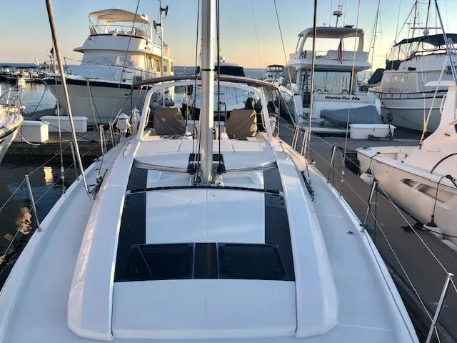 Slide: The Image of 2023 Beneteau Oceanis 46.1 sailboat docked at marina, surrounded by other yachts. - 17