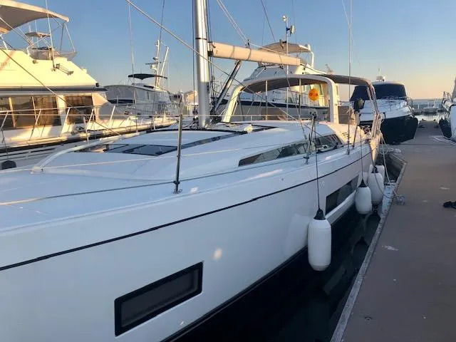 Slide: The Image of 2023 Beneteau Oceanis 46.1 yacht docked at marina during sunset. - 20