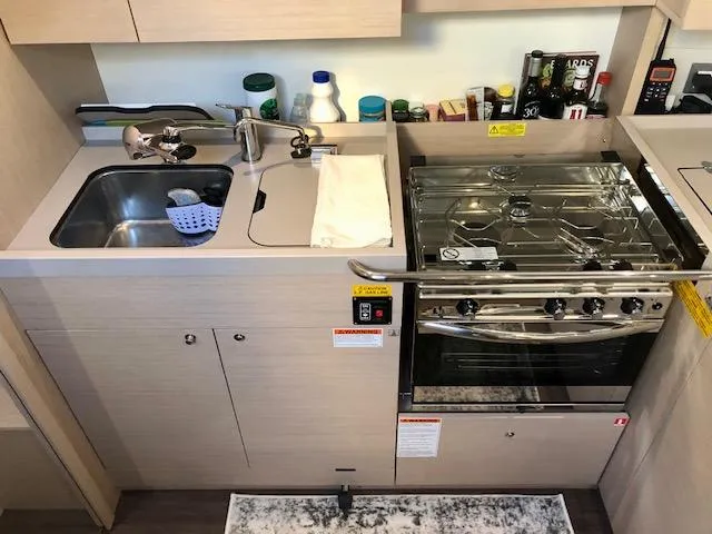 Slide: The Image of Compact kitchen in 2023 Beneteau Oceanis 46.1 yacht with sink and stove. - 25
