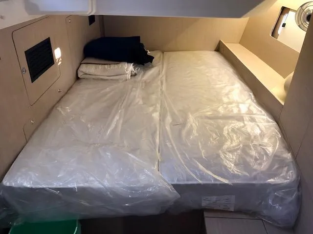 Slide: The Image of Cabin interior of 2023 Beneteau Oceanis 46.1 yacht with bed and storage. - 29