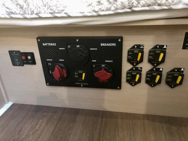 Slide: The Image of Electrical panel of 2023 Beneteau Oceanis 46.1 yacht, featuring battery and breaker controls. - 31