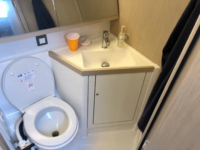 Slide: The Image of Bathroom in 2023 Beneteau Oceanis 46.1 yacht with toilet and sink. - 32