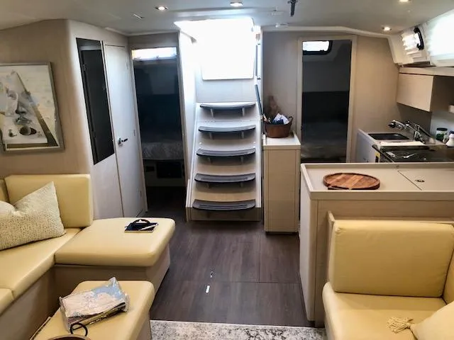 Slide: The Image of Luxurious interior of 2023 Beneteau Oceanis 46.1 yacht with modern kitchen and seating area. - 38