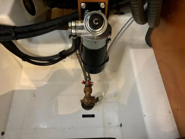 Slide: The Image of Engine compartment of 2023 Beneteau Oceanis 46.1 yacht, showing mechanical components and hoses. - 40