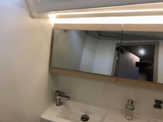 Slide: The Image of Modern bathroom interior of 2023 Beneteau Oceanis 46.1 yacht with mirror and sink. - 42