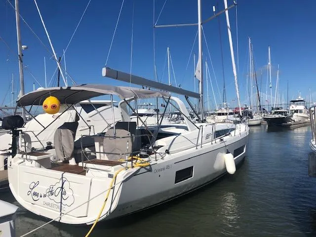 Slide: The Image of 2023 Beneteau Oceanis 46.1 yacht docked in marina under clear blue sky. - 48