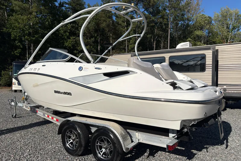 The Image of 2010 Sea-Doo Sport Boats 210 Challenger SE on trailer, parked outdoors. - 1