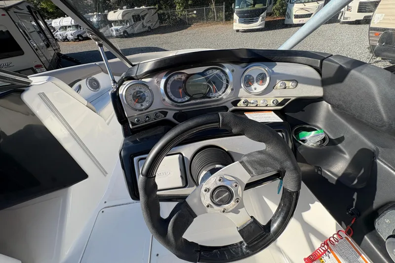 Slide: The Image of 2010 Sea-Doo 210 Challenger SE dashboard with steering wheel and gauges. - 11