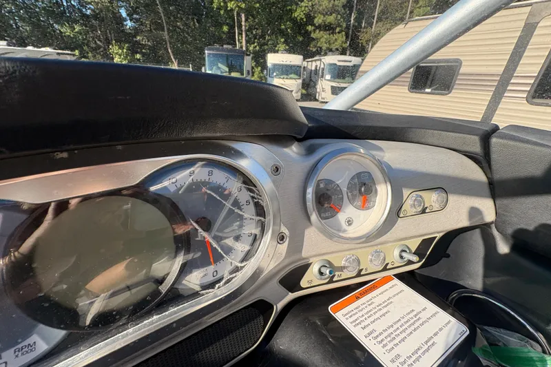 Slide: The Image of Dashboard of a 2010 Sea-Doo 210 Challenger SE boat with gauges and controls. - 18