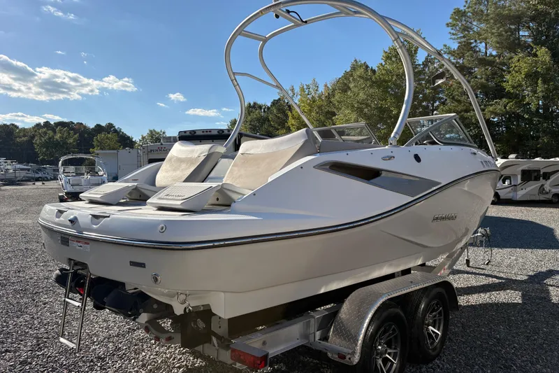 Slide: The Image of 2010 Sea-Doo 210 Challenger SE boat on trailer in outdoor setting. - 3
