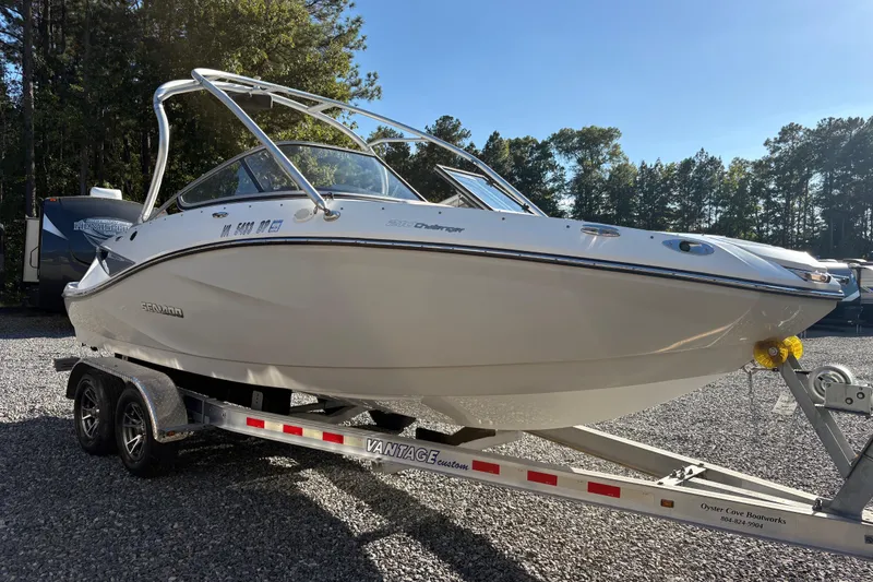 Slide: The Image of 2010 Sea-Doo 210 Challenger SE boat on trailer, parked outdoors. - 4