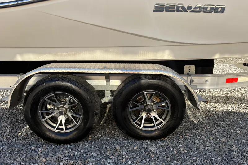 Slide: The Image of 2010 Sea-Doo 210 Challenger SE trailer wheels on gravel surface. - 5