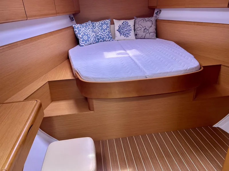 Slide: The Image of Interior cabin of 2012 Jeanneau 50 DS yacht with cozy bed and decorative pillows. - 23