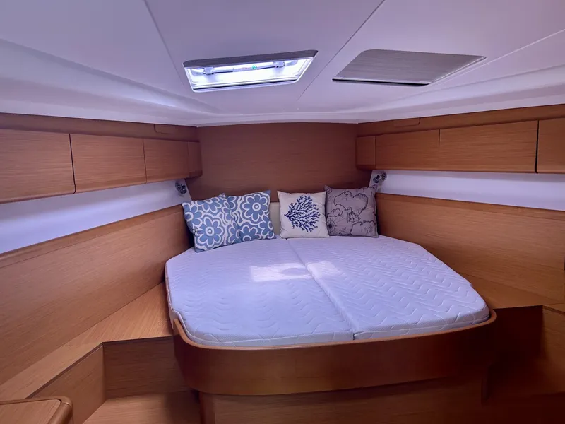Slide: The Image of Cozy cabin interior of 2012 Jeanneau 50 DS with comfortable bedding and wooden cabinetry. - 24