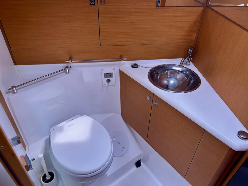 Slide: The Image of Bathroom of 2012 Jeanneau 50 DS yacht with modern fixtures and wooden cabinetry. - 25
