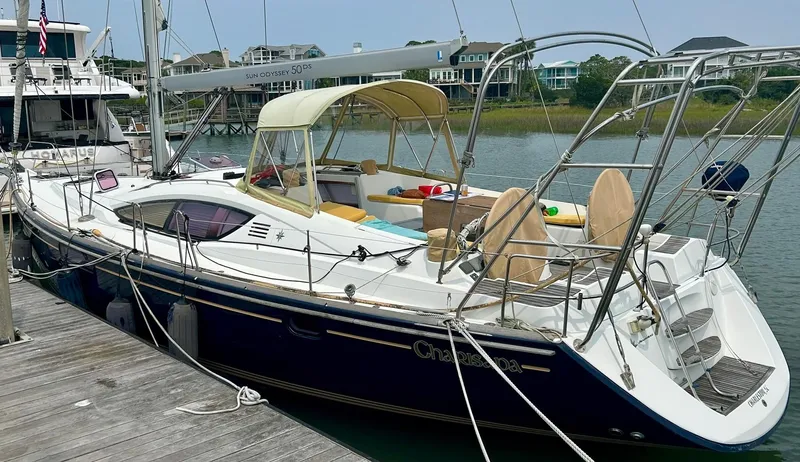 Slide: The Image of 2012 Jeanneau 50 DS sailboat docked, featuring sleek design and spacious deck. - 3