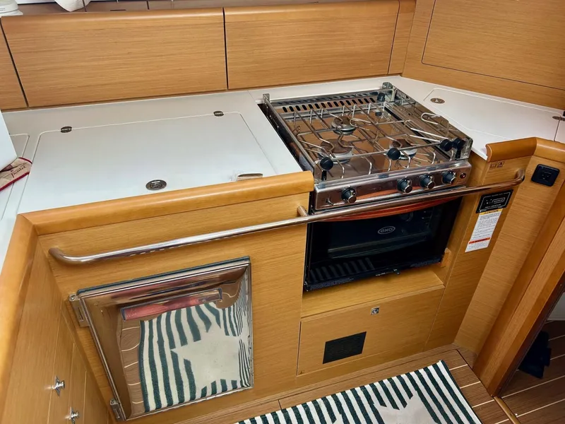 Slide: The Image of Modern kitchen area in a 2012 Jeanneau 50 DS yacht with stove and oven. - 30