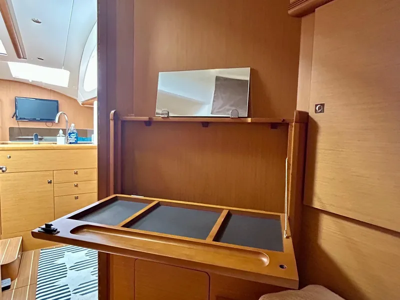 Slide: The Image of Interior of 2012 Jeanneau 50 DS yacht with wooden cabinetry and modern amenities. - 33
