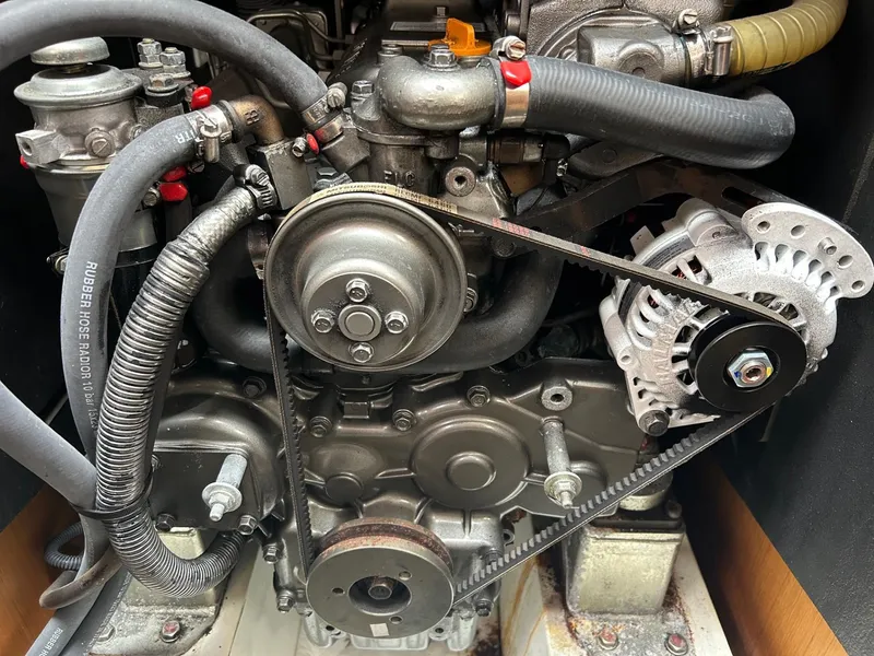 Slide: The Image of Engine of a 2012 Jeanneau 50 DS sailboat, showcasing belts and hoses. - 35