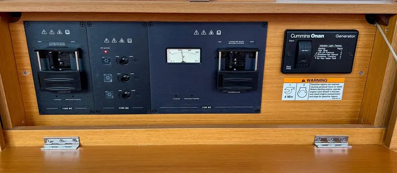 Slide: The Image of Electrical control panel on a 2012 Jeanneau 50 DS sailboat with Cummins Onan generator. - 36