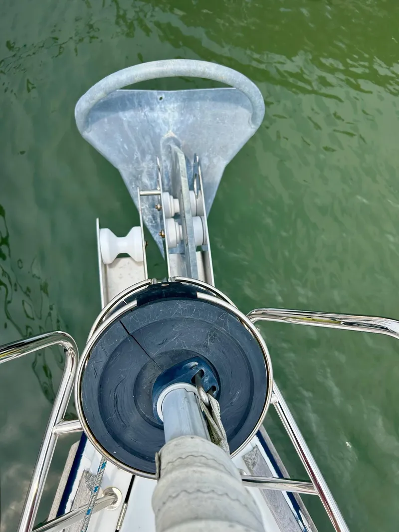 Slide: The Image of Jeanneau 50 DS 2012 sailboat anchor and bow detail over green water. - 7